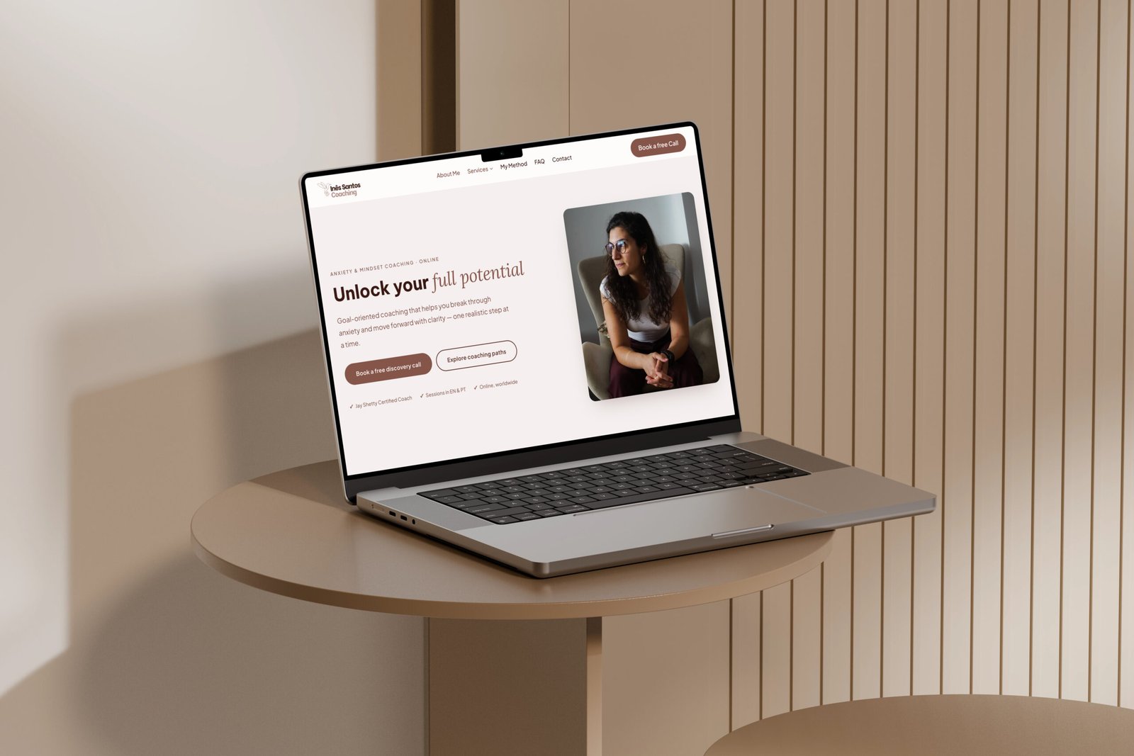 The Inês Santos Coaching homepage on a laptop: the headline Unlock your full potential, a photo of Inês, and one main button, Book a free discovery call.